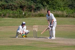 COLEMAN'S HATCH, SUSSEX, UK, 2009. Village cricket being played at Coleman's Hatch in Sussex on June 27, 2009. Two unidentified people. photo