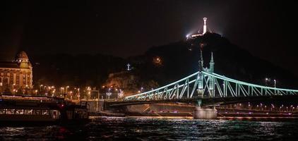 Budapest, Hungary, 2014. Liberty Bridge and Statue illuminated at night in Budapest photo