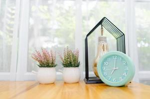 Light green alarm clock Placed on the table in the bedroom photo