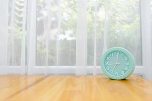 Light green alarm clock Placed on the table in the bedroom photo