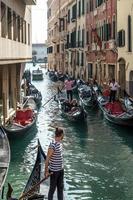 Venice, Veneto, Italy, 2014. Gondoliers ferrying passengers in Venice photo