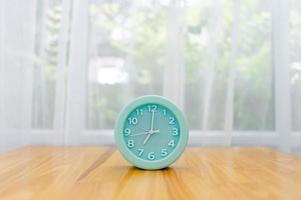 Light green alarm clock Placed on the table in the bedroom photo