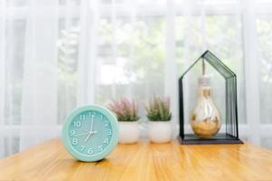 Light green alarm clock Placed on the table in the bedroom photo