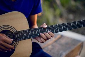 Hands and guitars of guitarists playing guitar concepts, musical instruments photo