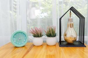 Light green alarm clock Placed on the table in the bedroom photo