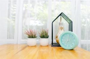 Light green alarm clock Placed on the table in the bedroom photo
