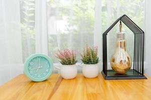 Light green alarm clock Placed on the table in the bedroom photo