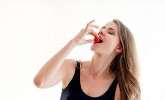 Healthy concept, eat tomatoes, diet, home and happiness. sporty teenage girl Smile with fresh salad at home photo