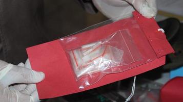 Evidence of drug crimes, types of methamphetamine in the hands of police photo