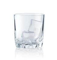 Ice cubes in empty glass on white background. Glass of water or whiskey and wine. Empty glass for alcoholic beverages photo