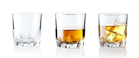 Set of alcoholic beverages. Scotch whiskey in elegant glass with ice cubes on white background. photo