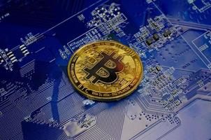 Golden bitcoin cryptocurrency new version on computer electronic circuit board background photo