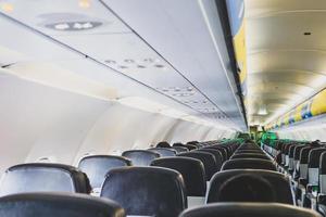 Rows of airplane seats in the airplane cabin photo