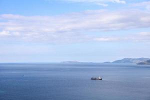 fondo marino con barco de pesca navegando bajo un cielo azul foto