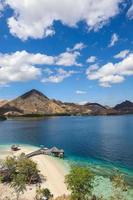 Exotic island and gazebo on the beach with seascape and hills photo