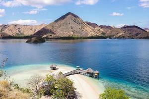 Exotic island and gazebo on the beach with seascape and hills photo