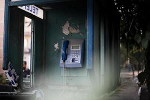 Old blue telephone booth with numbers with cinematic light in Istanbul photo