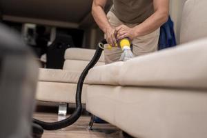 Cleaning a dirty sofa with a sofa washer photo