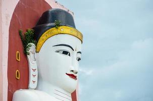 One of the four big Buddha images sitting back to back in Kyaik Pun pagoda, one of tourist attraction place in Bago town, Myanmar. photo