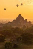 Group of the hot air balloons flying over Dhammayangyi temple in Bagan plain at dawn. Bagan now is the UNESCO world heritage site and the first kingdom of Myanmar.