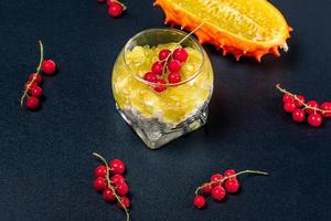 Diet food-cottage cheese with kiwano and red currant on a dark background