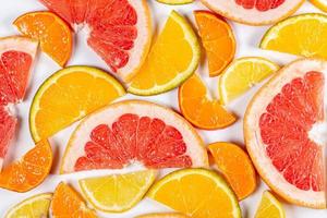 Citrus background with slices of juicy fresh fruit, top view