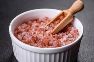 Pink and white large Himalayan salt in a white saucer photo