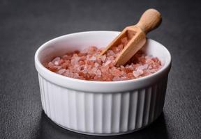 Pink and white large Himalayan salt in a white saucer photo