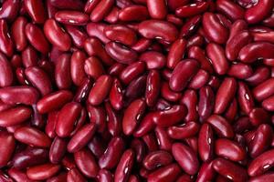 Beans of red dry raw beans on a dark concrete background