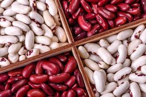 Beans of red and white dry raw beans on a dark concrete background photo