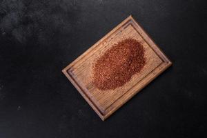 Rooibos tea on a black background. Flat lay, copy space photo