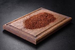 Rooibos tea on a black background. Flat lay, copy space photo