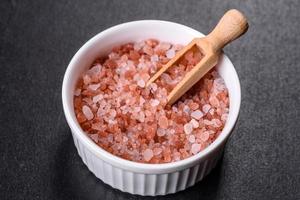 Pink and white large Himalayan salt in a white saucer photo