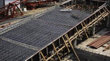 High angle and diagonal view of reinforcement metal framework for concrete pouring on ramp way structure in construction site photo