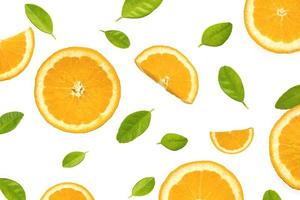 Flat lay of orange slices with green leaves on white background photo