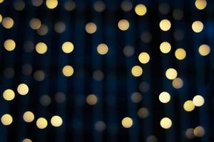 Blurred abstract hanging decorative lights with bokeh in night background photo