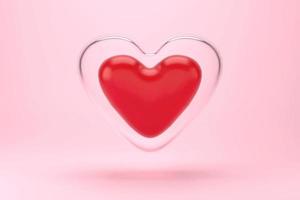 Small red heart that is covered by a large glass heart  isolate on pink background, 3D rendering photo