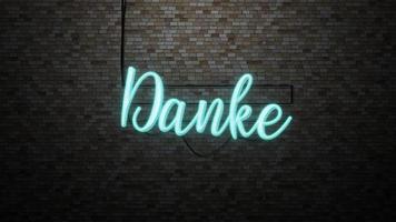 The message Danke  neon light on Brick wall bcakground photo