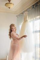 Morning of a beautiful young bride in a boudoir dress. photo