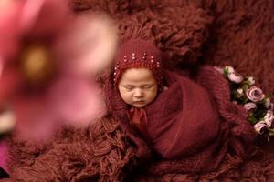 Newborn baby sleeping on flocci photo
