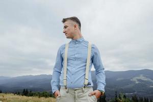 Photoshoot of the groom in the mountains. Boho style wedding photo. photo