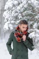 Portrait of a bearded groom in a stylish suit with suspenders and bow-tie in winter at a ski resort photo