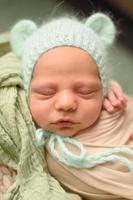 Closeup portrait of newborn baby with smile on face. Healthy and medical concept. photo