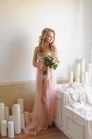 Morning of a beautiful young bride in a boudoir dress. photo