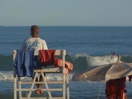 Buenos Aires, Argentina, 2021. Lifeguard in his post on a high chair photo