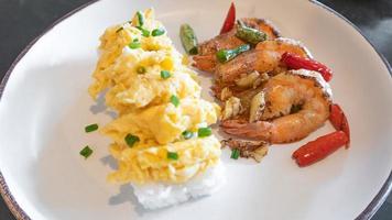 Stir fried crispy shrimp with chilies salt garlic with rice and scrambled eggs. photo