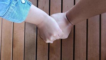 Male and female couple hands in hands build love relationship photo