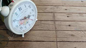 Brown painted old wooden background decorated with clock photo