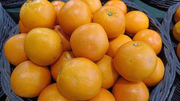 Fresh orange fruits in the basket photo
