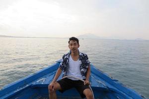 Man on wooden boat photo